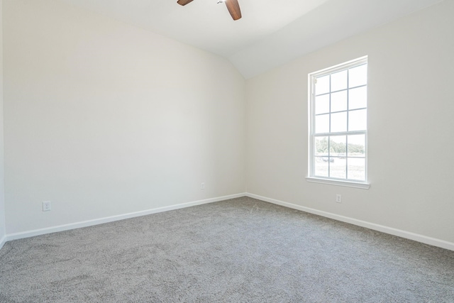 carpeted spare room with lofted ceiling and ceiling fan