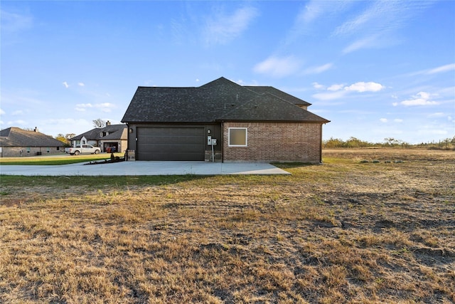 view of home's exterior featuring a garage and a lawn