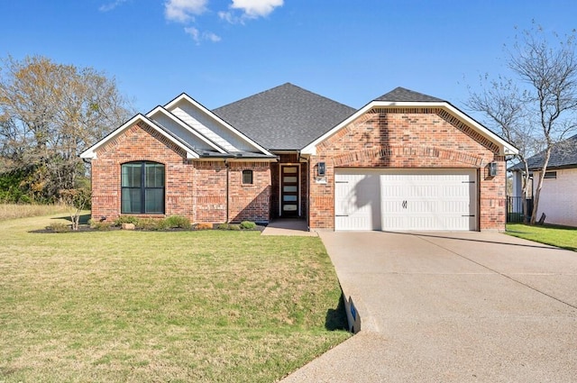 view of front of property with a front yard and a garage