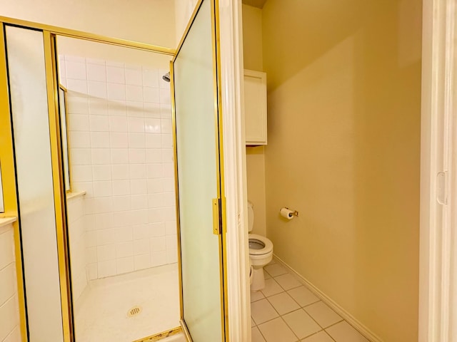 bathroom with tile patterned flooring, toilet, and a shower with shower door