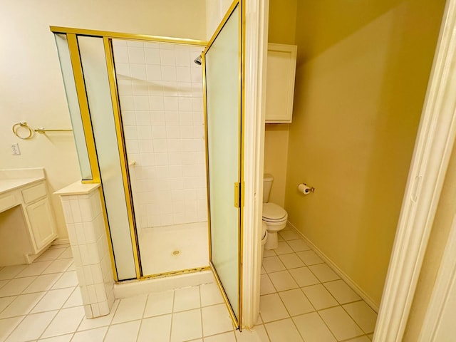 bathroom featuring vanity, tile patterned floors, toilet, and walk in shower