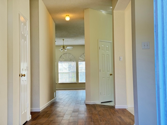 hall featuring dark hardwood / wood-style flooring and a textured ceiling