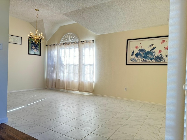 empty room with a chandelier, a textured ceiling, and vaulted ceiling