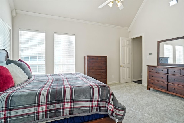 bedroom featuring light colored carpet, vaulted ceiling, multiple windows, and ceiling fan