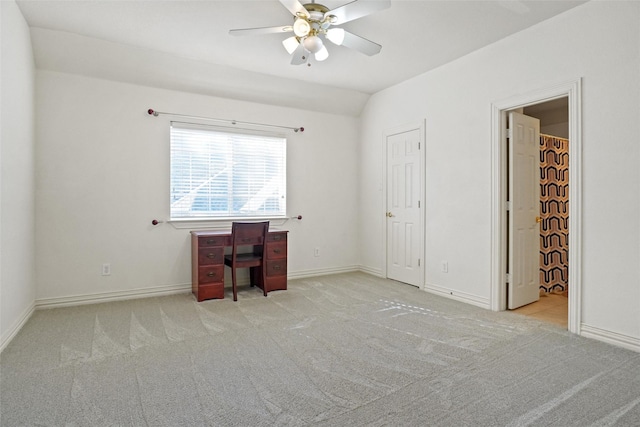 unfurnished office with light carpet, ceiling fan, and lofted ceiling