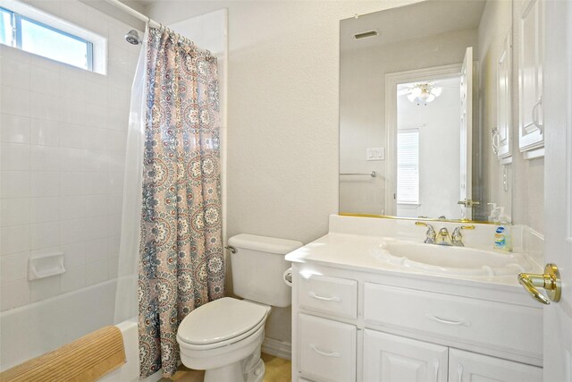 full bathroom with vanity, shower / tub combo, and toilet