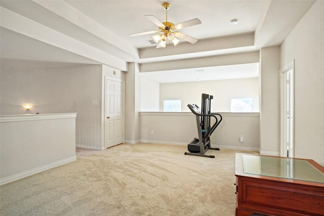 exercise area with light colored carpet and ceiling fan