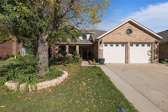 view of front of house with a front yard and a garage