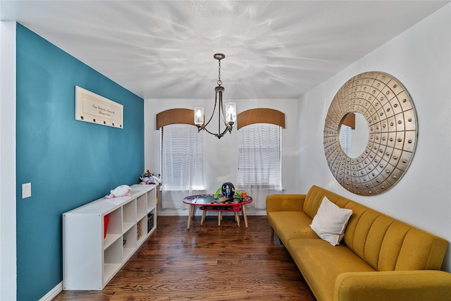 interior space with a notable chandelier and dark hardwood / wood-style flooring