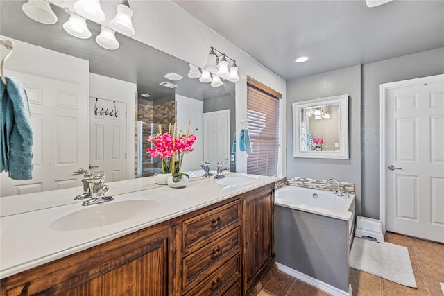 bathroom featuring vanity, a textured ceiling, separate shower and tub, and tile patterned floors