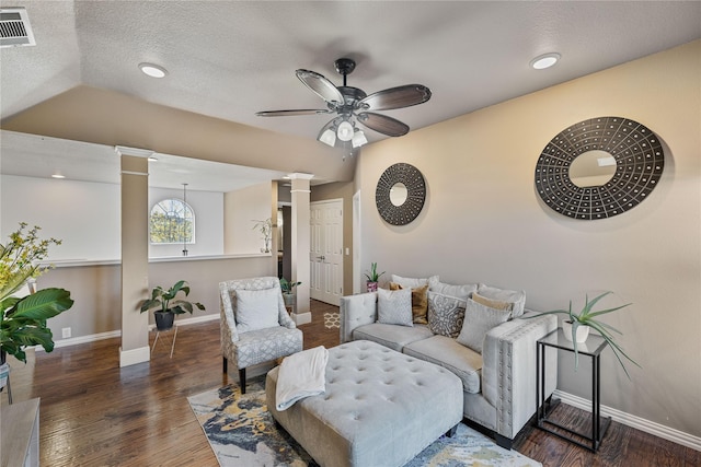 living room with dark hardwood / wood-style flooring, decorative columns, a textured ceiling, ceiling fan, and lofted ceiling