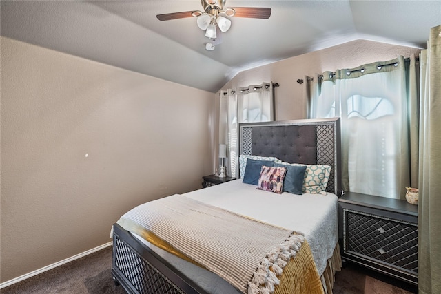 bedroom with ceiling fan, dark carpet, and lofted ceiling