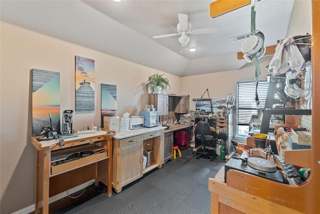 carpeted home office featuring ceiling fan and vaulted ceiling