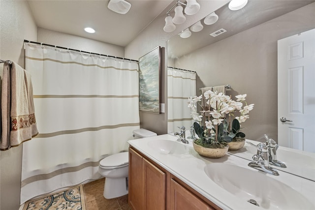 bathroom featuring tile patterned floors, vanity, and toilet