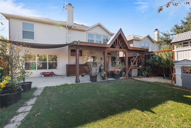 rear view of property featuring a storage shed, a patio area, and a lawn