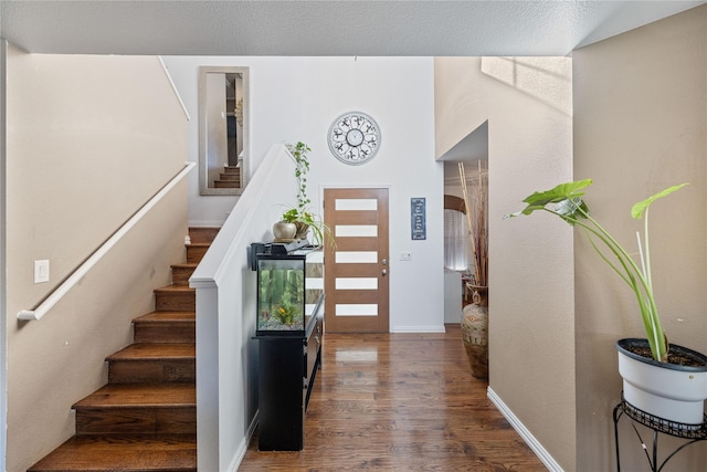 entrance foyer featuring dark hardwood / wood-style flooring and a textured ceiling