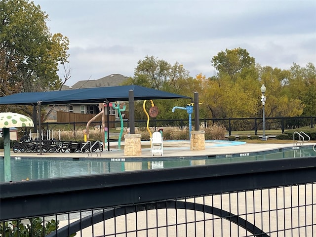 view of swimming pool with a playground