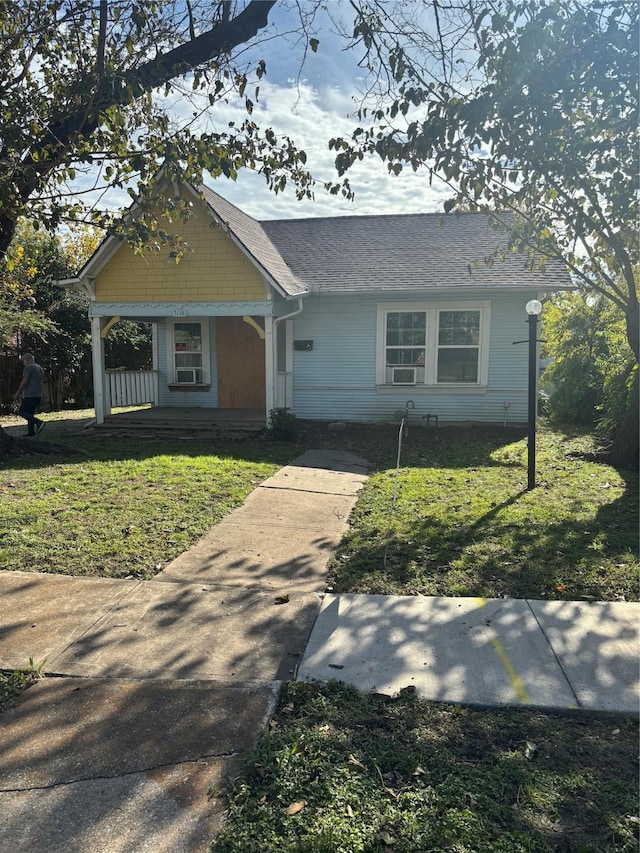 view of front of home featuring a front yard and a porch