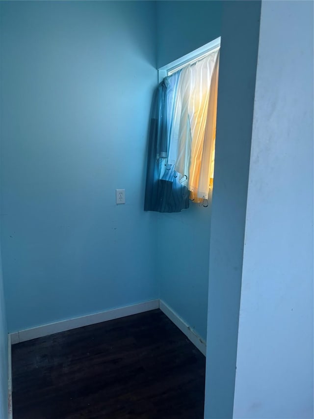 spare room featuring dark wood-type flooring