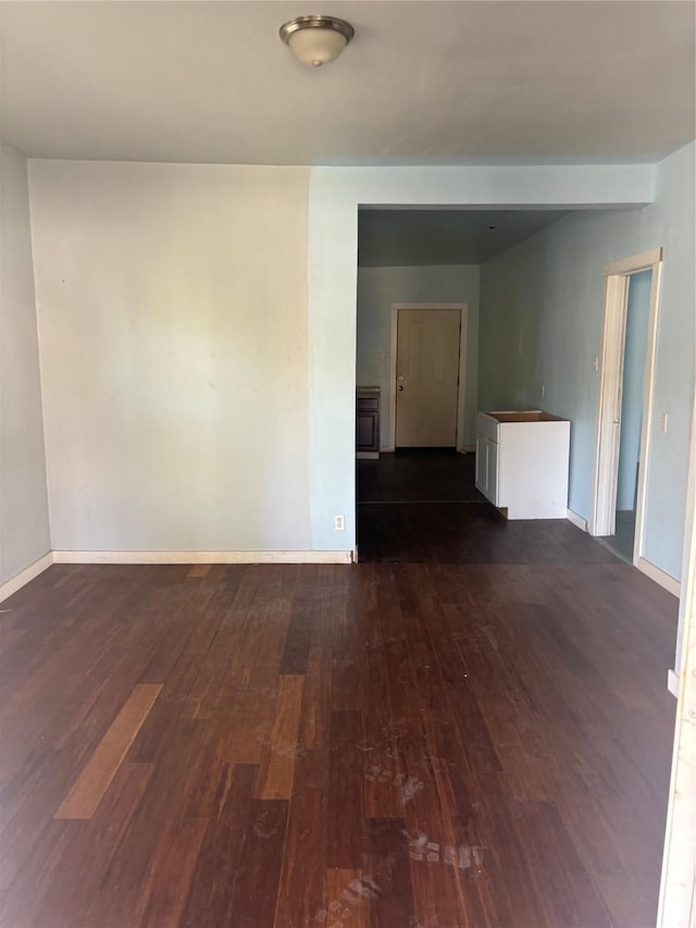 empty room with dark hardwood / wood-style flooring