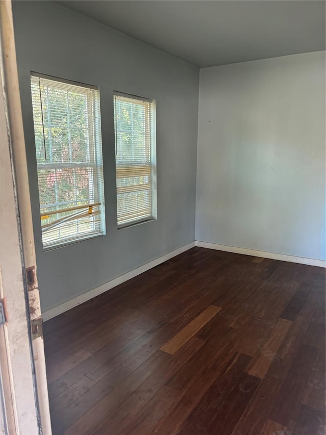 spare room featuring dark wood-type flooring