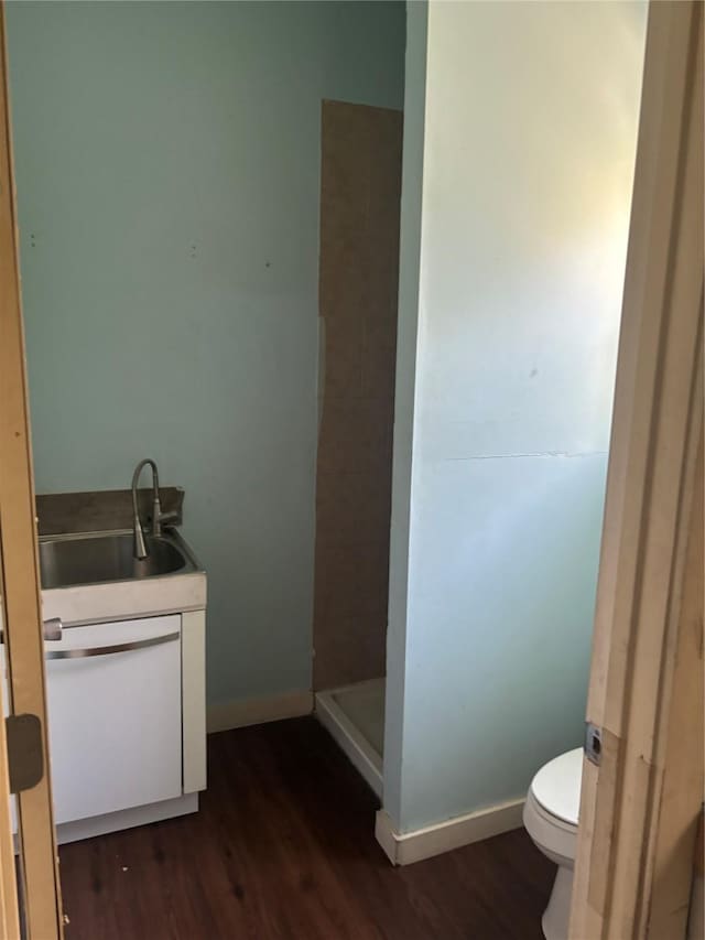 bathroom featuring vanity, hardwood / wood-style flooring, toilet, and walk in shower