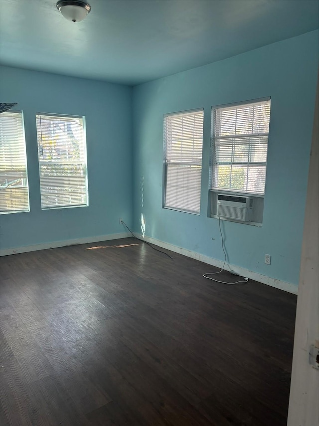 empty room with dark hardwood / wood-style flooring