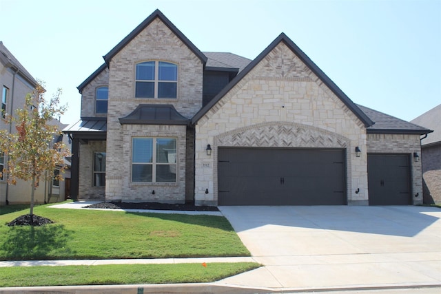 view of front of home with a garage and a front lawn