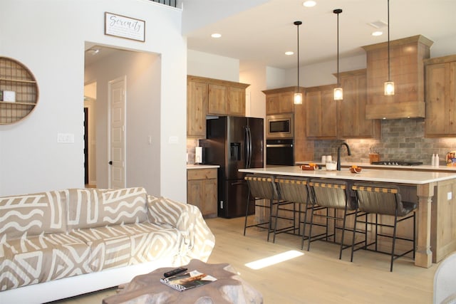 living room with light hardwood / wood-style flooring and sink