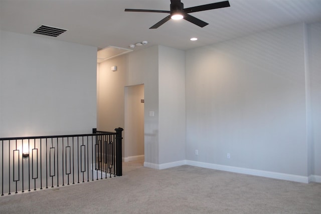 unfurnished room featuring light carpet and ceiling fan