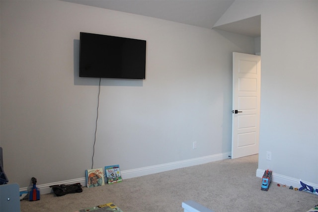 unfurnished bedroom with carpet floors and lofted ceiling