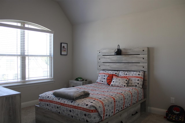 bedroom featuring light colored carpet and vaulted ceiling