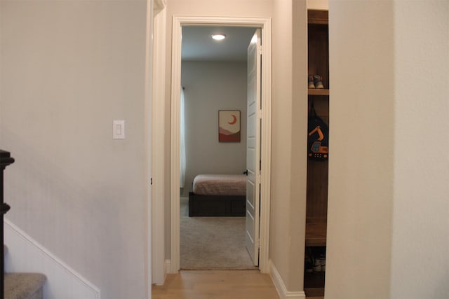 corridor with light hardwood / wood-style floors