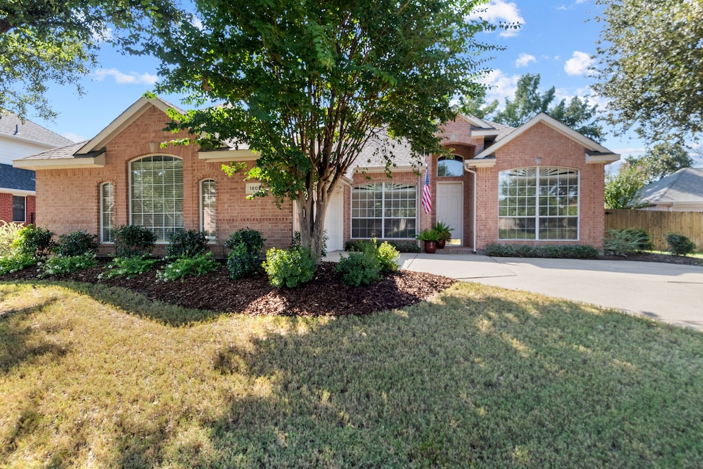 ranch-style house with a front lawn