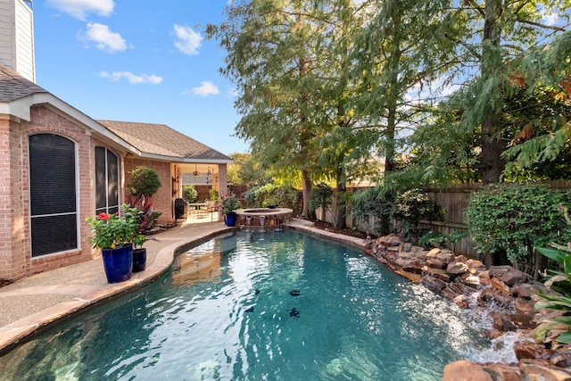 view of swimming pool with an in ground hot tub and a patio