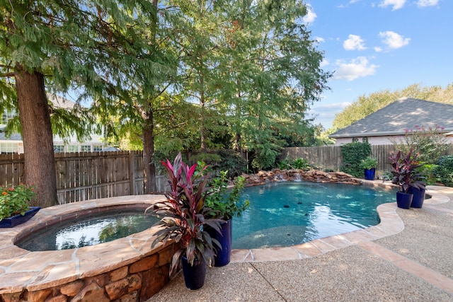 view of swimming pool featuring an in ground hot tub