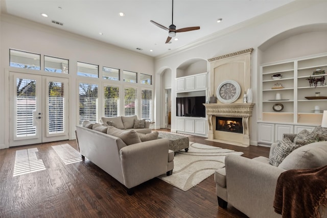 living room featuring french doors, crown molding, ceiling fan, and dark wood-type flooring