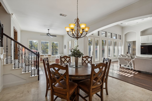 dining room with ceiling fan with notable chandelier, plenty of natural light, and crown molding