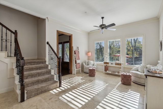 sitting room with ceiling fan and ornamental molding