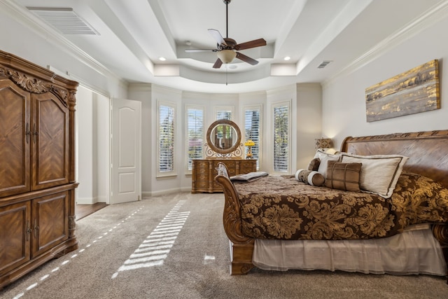 bedroom with a raised ceiling, ceiling fan, crown molding, and light colored carpet