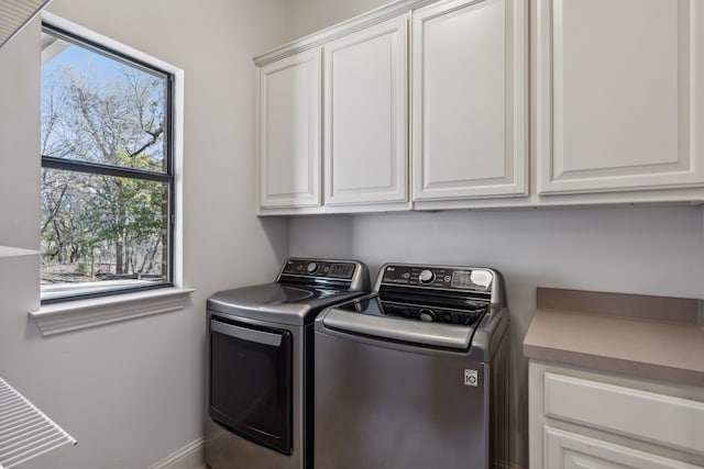 laundry area with cabinets and independent washer and dryer