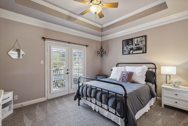 carpeted bedroom featuring access to exterior, french doors, ornamental molding, a tray ceiling, and ceiling fan