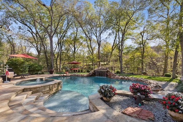 view of swimming pool with pool water feature