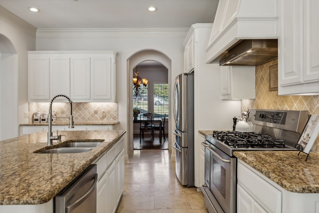 kitchen featuring white cabinets, sink, dark stone countertops, appliances with stainless steel finishes, and custom range hood