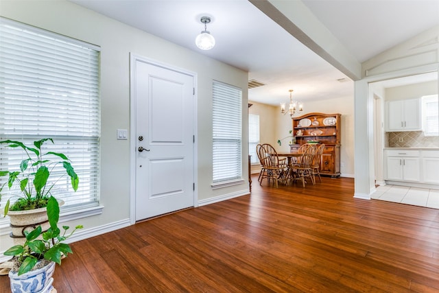 entryway featuring light hardwood / wood-style floors and a notable chandelier