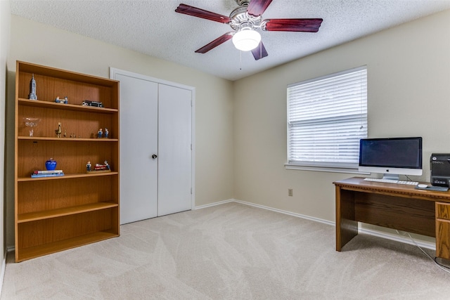 home office with ceiling fan, light colored carpet, and a textured ceiling