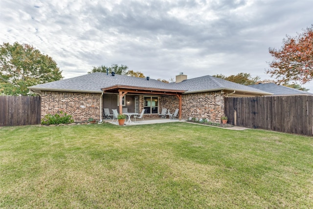 back of property featuring a patio and a lawn