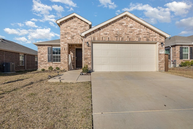 view of front of property featuring a garage and central AC unit