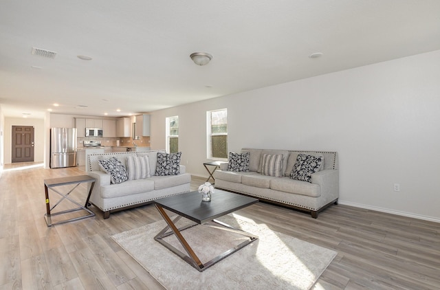 living room with light hardwood / wood-style flooring