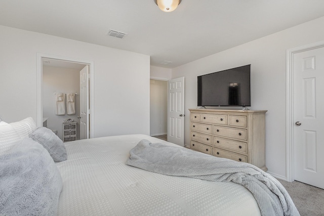 bedroom with carpet floors and ensuite bathroom